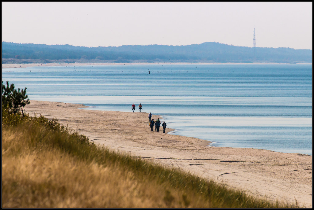 Mężczyzna z walizką nad morzem przed wyjazdem do pracy w delegacji zagranicznej